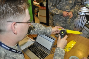 Spc John Turner with 19th Regiment, 1st Battalion, scans a Texas Emergency Tracking Network (TETN) band to provide to shelter evacuees at Balch Springs Recreation Center, during a mock hurricane exercise, June 7, 2014