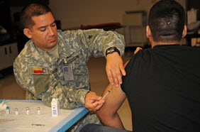 Getting shots is part of the care provided at Operation Lone Star, a joint civilian and military operation each summer in South Texas. Personnel of the Medical Brigade of the Texas State Guard contribute significantly to mission success. (Photo by Texas Air Guard Senior Master Sgt. Michael Arellano.)
