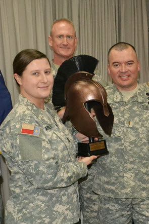 OCS Commander CPT JoAnna Carle displays her gift from Class 14 with graduates Second Lieutenant Roy Lopez (Front) and Second Lieutenant Michael Ross (Back). Photo Credit: Capt. Shawn James